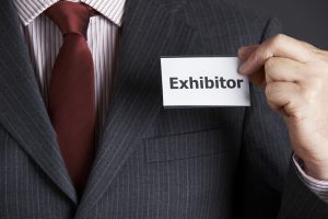 man in suit with exhibitor name tag