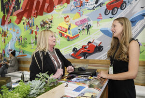 two women meeting at a trade show booth