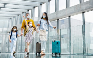 family walking through airport with masks on