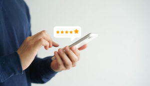 close up of customer writing a review on a cell phone
