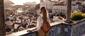 Scene with a female tourist who is walking on the street of a city with breathtaking view