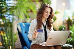 woman making purchase on computer with credit card