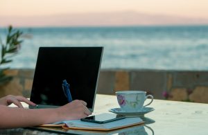Woman working from computer at a beach