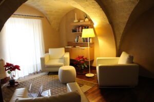 Relaxed mood interior reading room with white leather armchairs and warm light