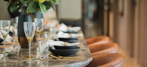 photo of three place mats with bowls, silverware and water glasses, modern and simple. 