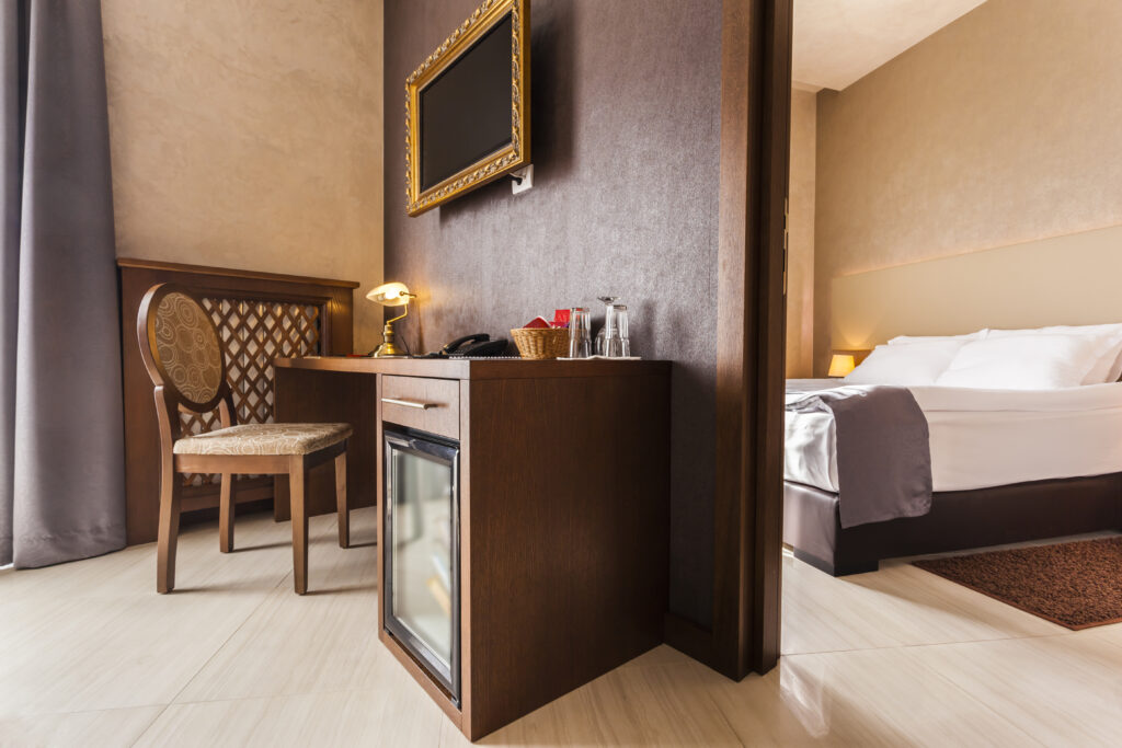 Interior of a modern hotel room with a full equipped mini fridge making dry-tripping easier