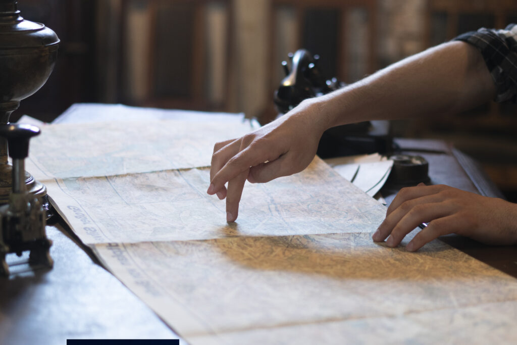 Traveler pointing at a map, symbolizing astrocartography journeys and exploring destinations through astrology.