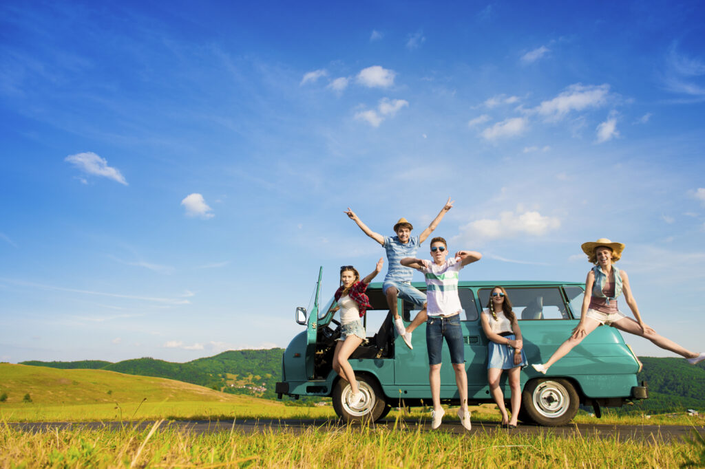Young hipster friends on road trip on a summers day.