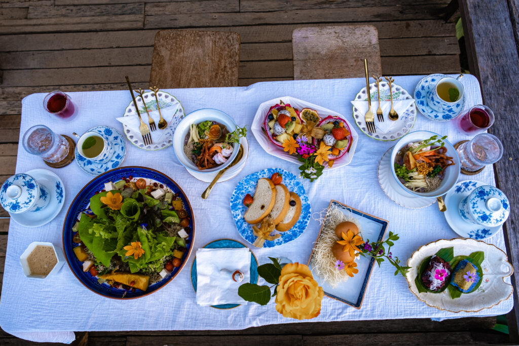 A breakfast display filled with fresh vegetables and fruit with refreshing waters and teas.