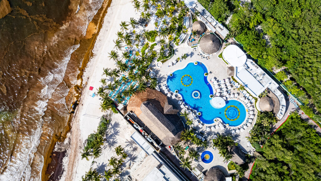 Drone images of Xpu-Ha Beach during sargassum season spotlighting Hard Rock Hotel in Riviera Maya. 