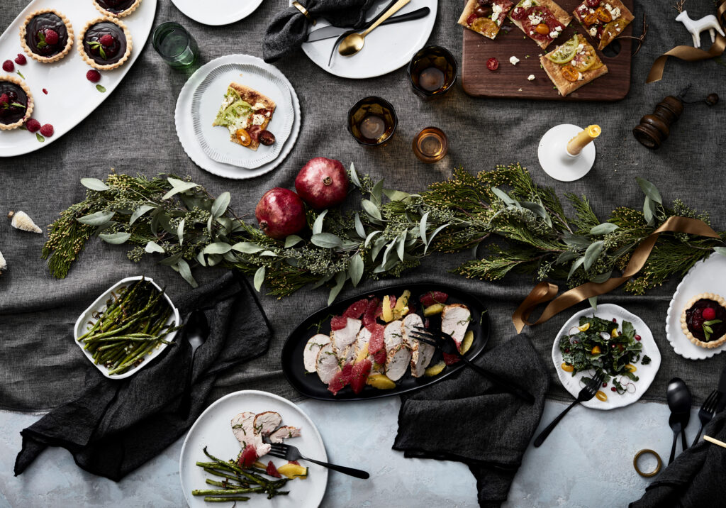 Elegant holiday table with assorted savory and sweet dishes.