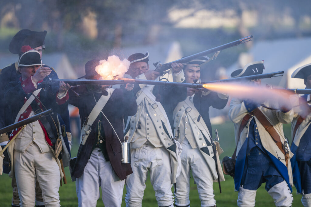 Soldiers reenacting the American Revolution war at Huntington Beach Central Park, a nod to America's 250th.