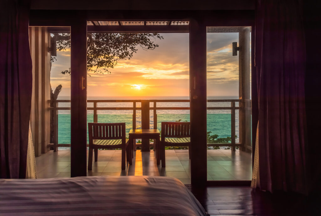 A stunning view of the sun setting over the ocean from a luxury hotel room, an ideal snapshot that works well for instagram reels marketing. 